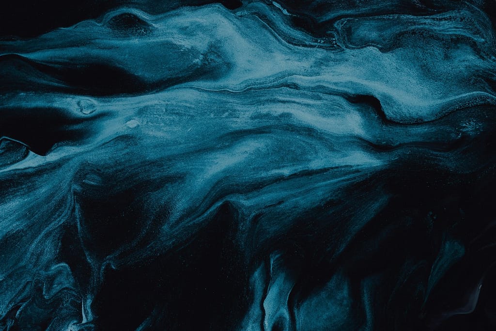 Blue Ink Swirls Flowing Across a White Canvas