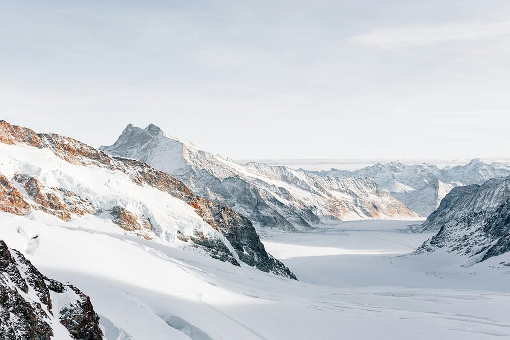 Snowy Mountain Peaks Bathed in Pink Alpenglow Light