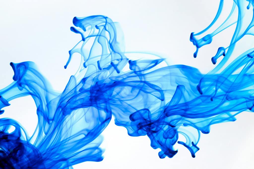 Swirling Ink in Water with Glowing Gold Leaf Accents