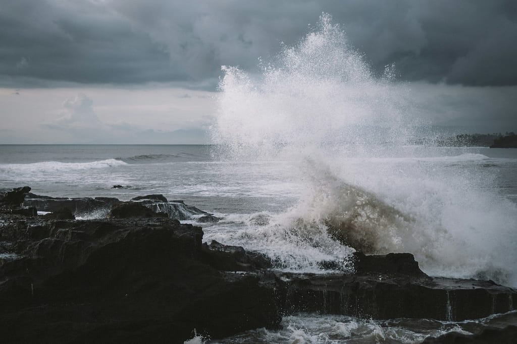 Turquoise Ocean Waves Crashing on Black Volcanic Cliffs