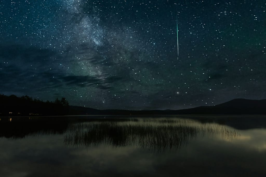Meteor Shower Falling Over a Mountain Lake at Night