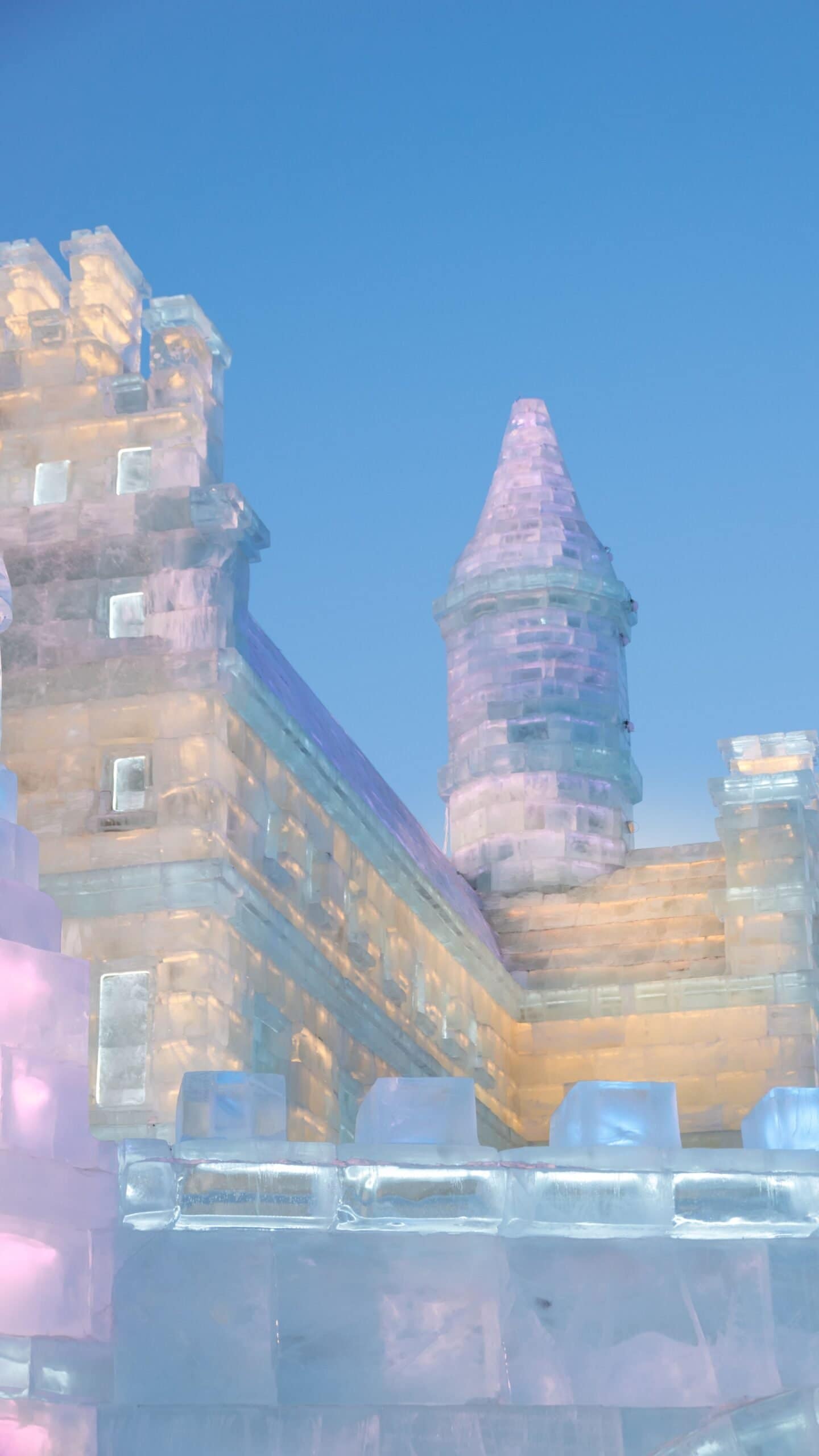 Majestic Ice Castle Glowing Under a Winter Sky