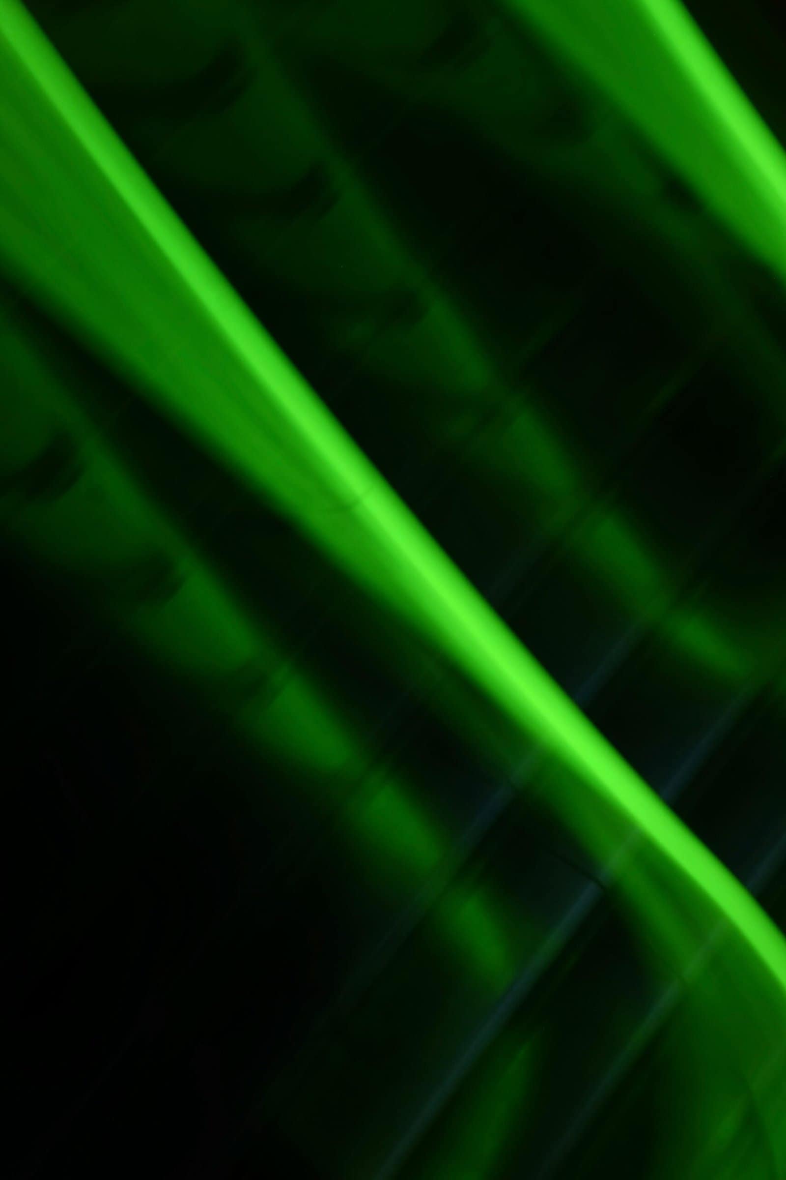 Emerald Light Streaks Crossing Black Canvas