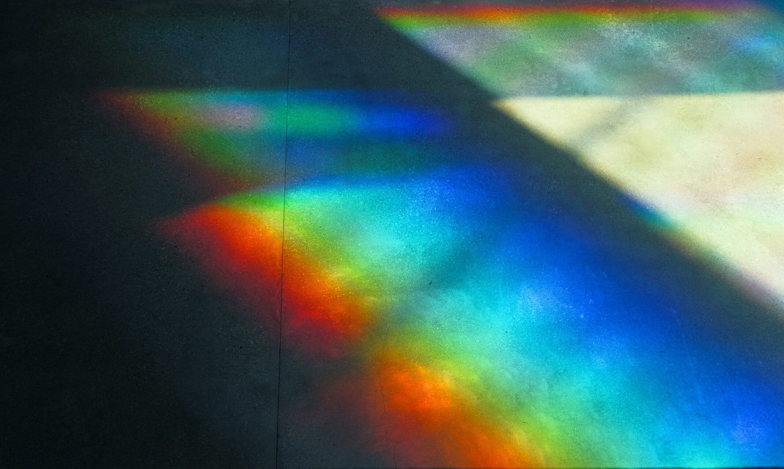 Rainbow Light Prisms Scattering on a Glass Wall