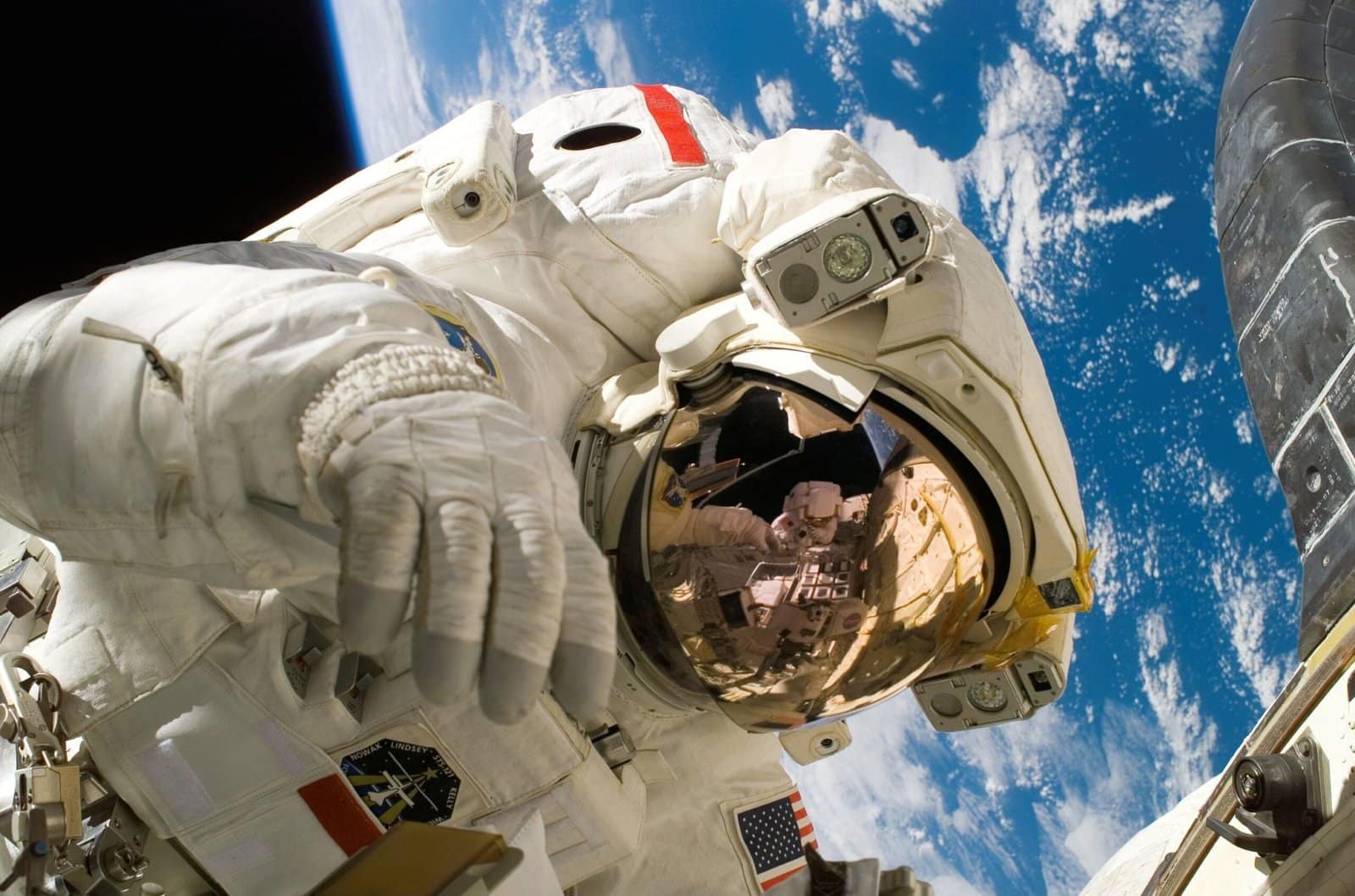 Astronaut Drifting Beside a Glowing Space Station