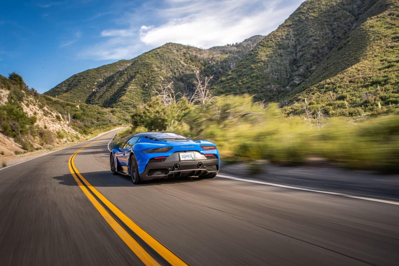 Blue Sports Car on Mountain Road at Sunrise