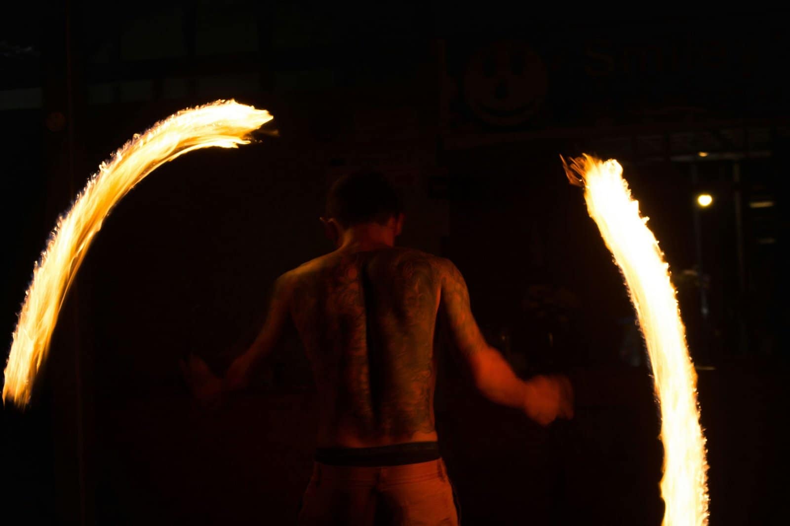 Fire Dancer Spinning Flames Under Night Sky