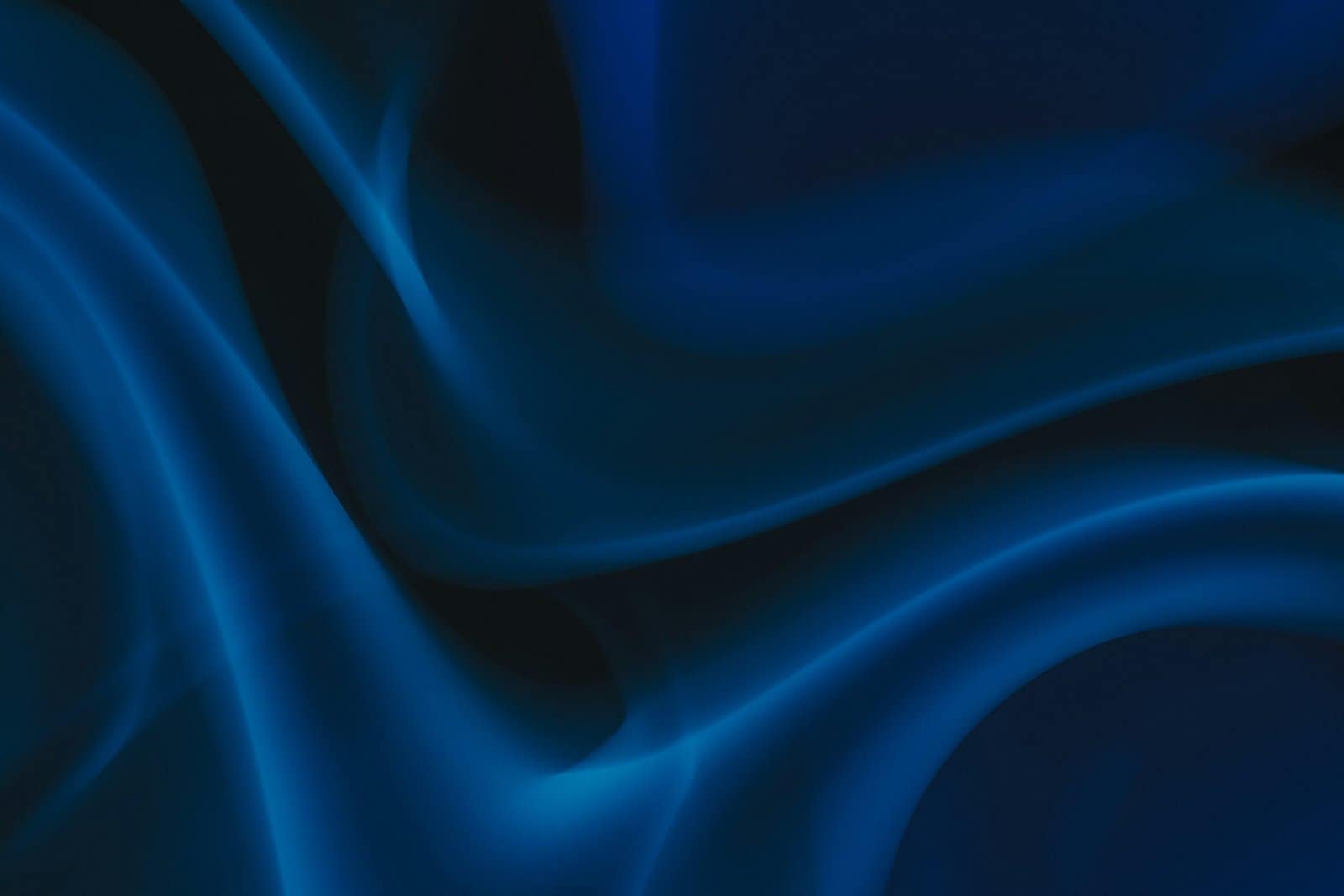 Flowing Blue Silk Waves on a Dark Background