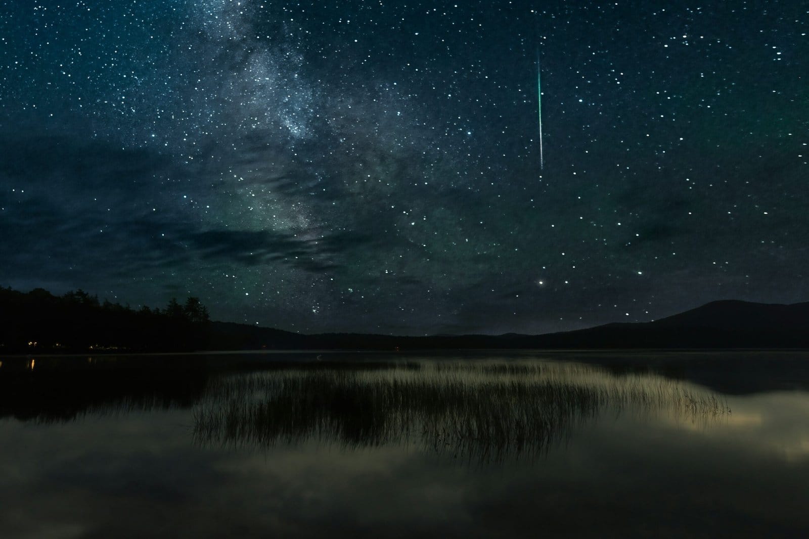 Meteor Shower Falling Over a Mountain Lake at Night