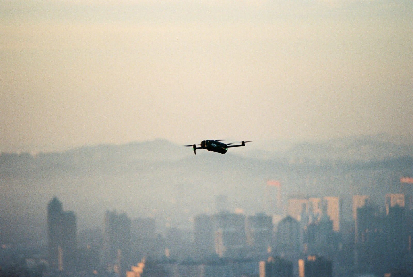 Futuristic Drone Hovering Over a City at Dawn