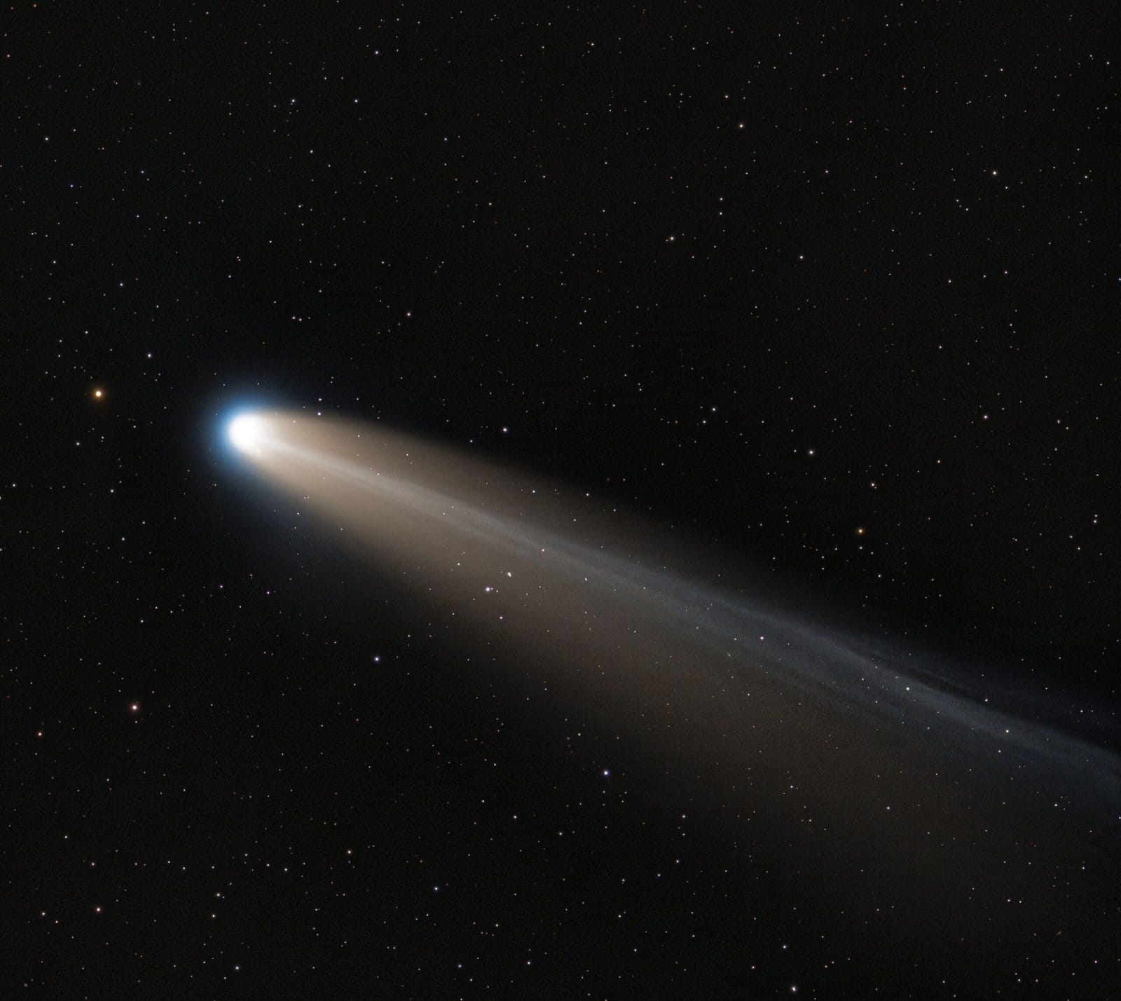 Comet Streaking Across Starry Night Sky