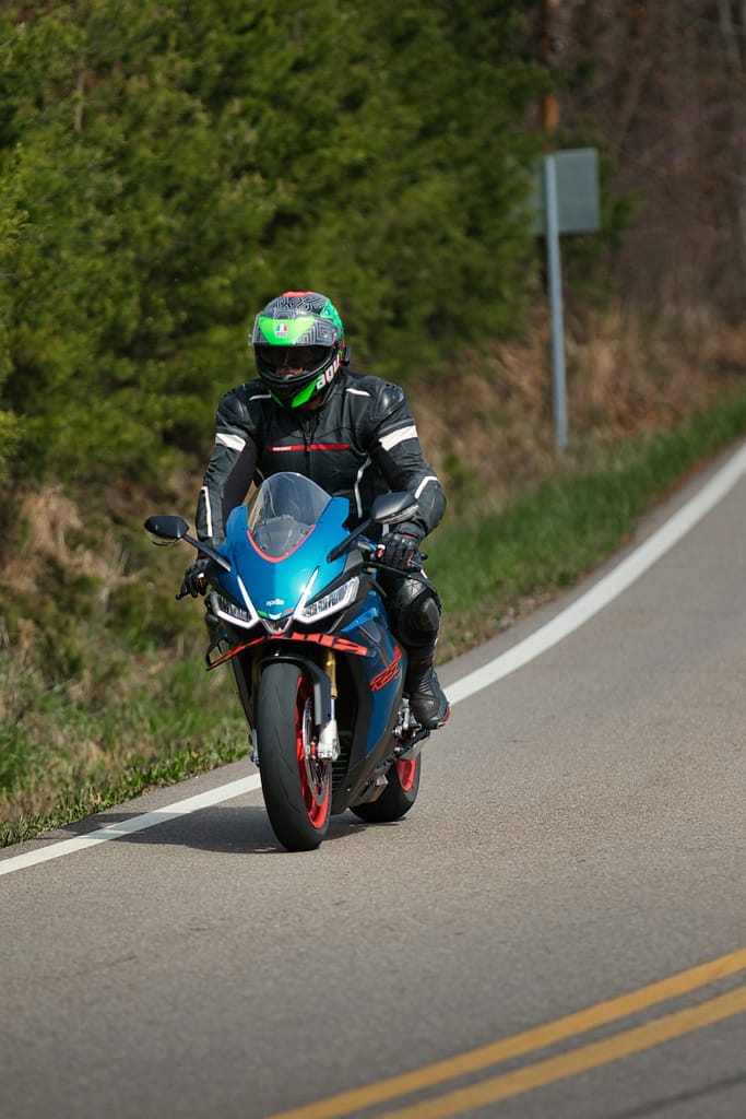 Blue Adventure Motorcycle Riding Through Mountain Pass