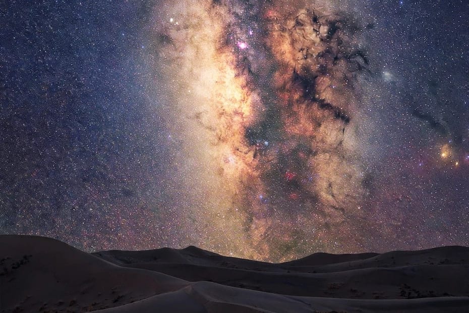 Starry Night Sky and Galactic Core Over Desert Dunes