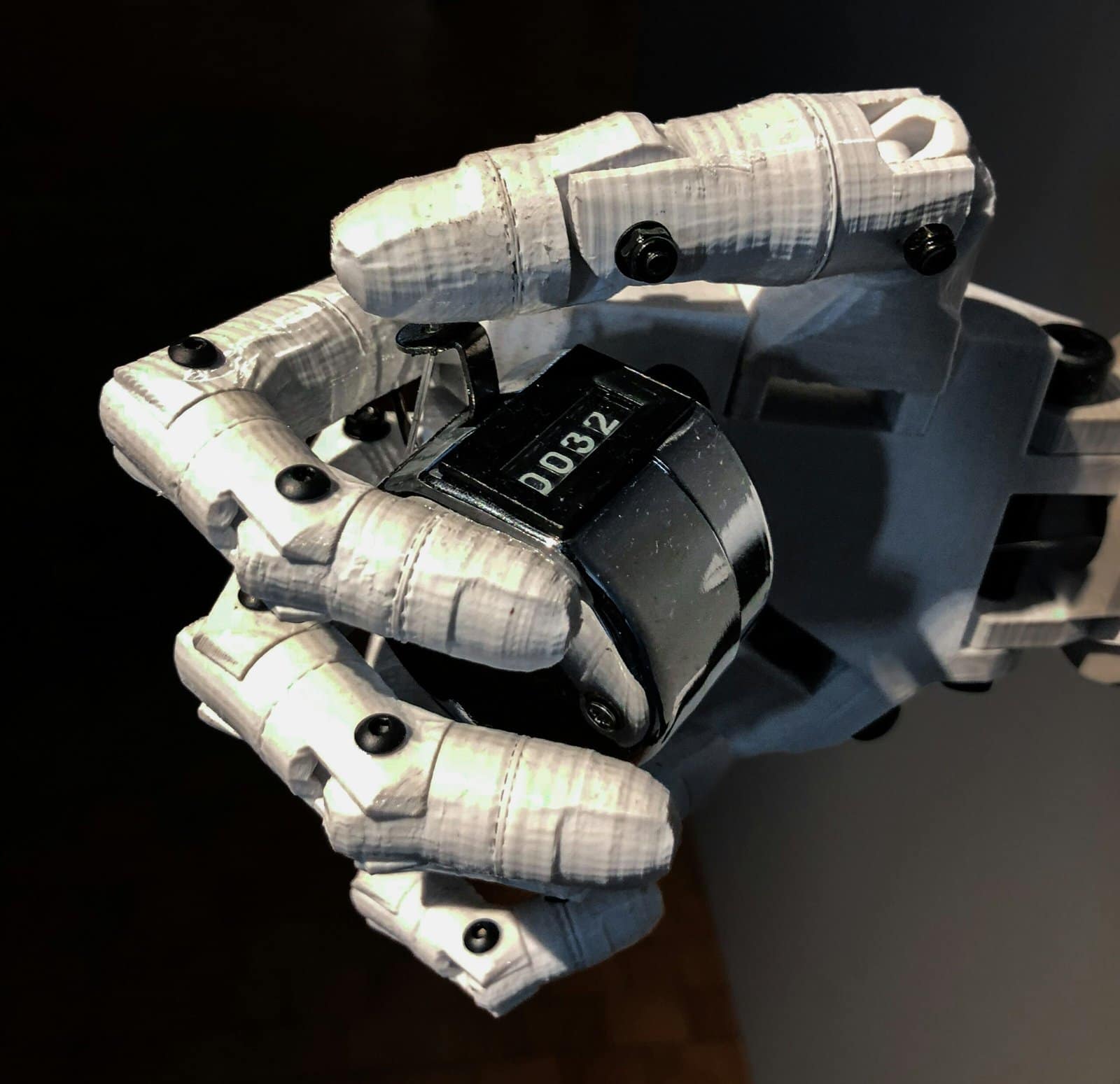Close-Up of a Robot Hand Holding a Cell Phone