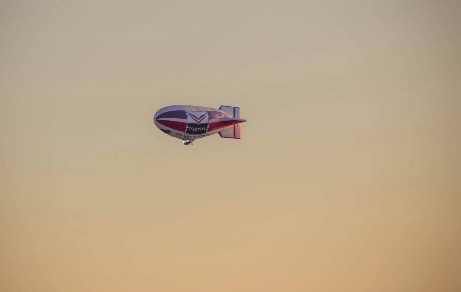 Steampunk Airship Sailing Through Sunset Clouds