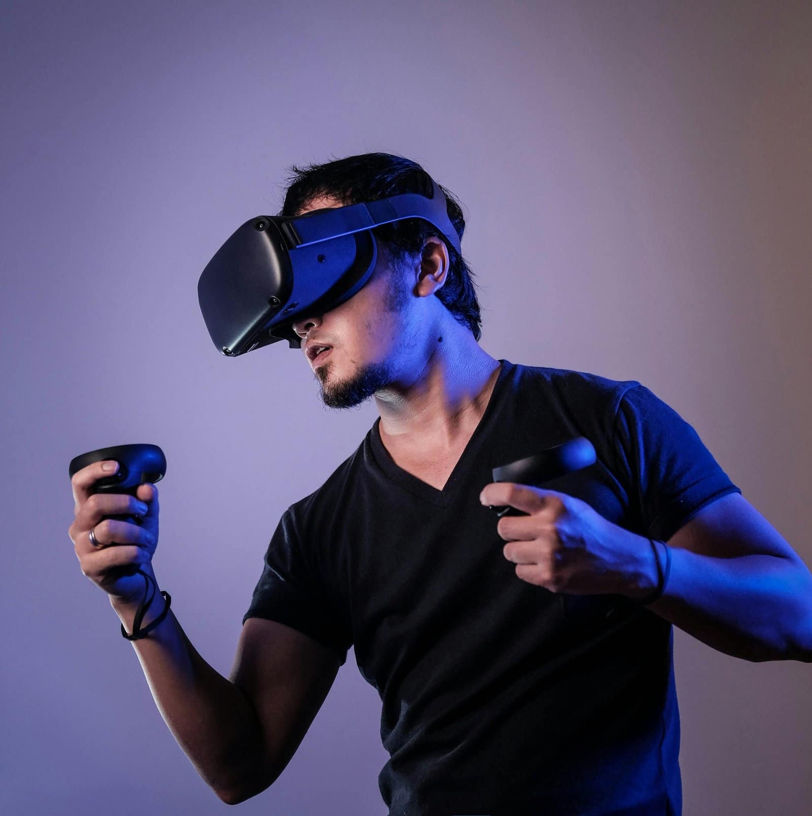 Virtual Reality Gamer Wearing Headset In Dark Room