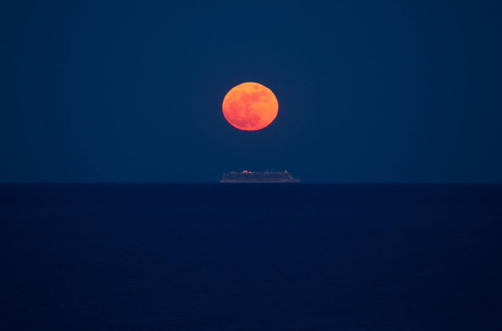 Lunar Eclipse Glowing Red Above Silent Ocean