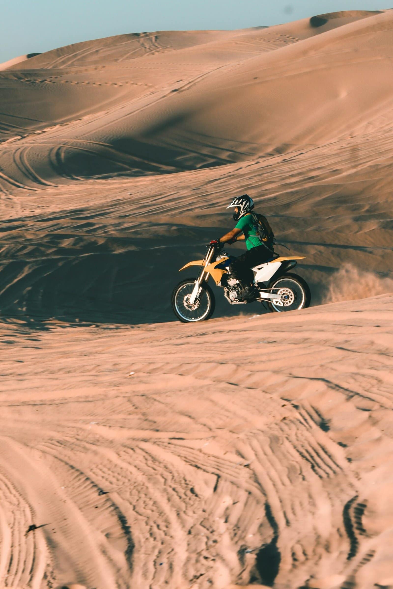 Motorcycle Riding Through Desert Dunes