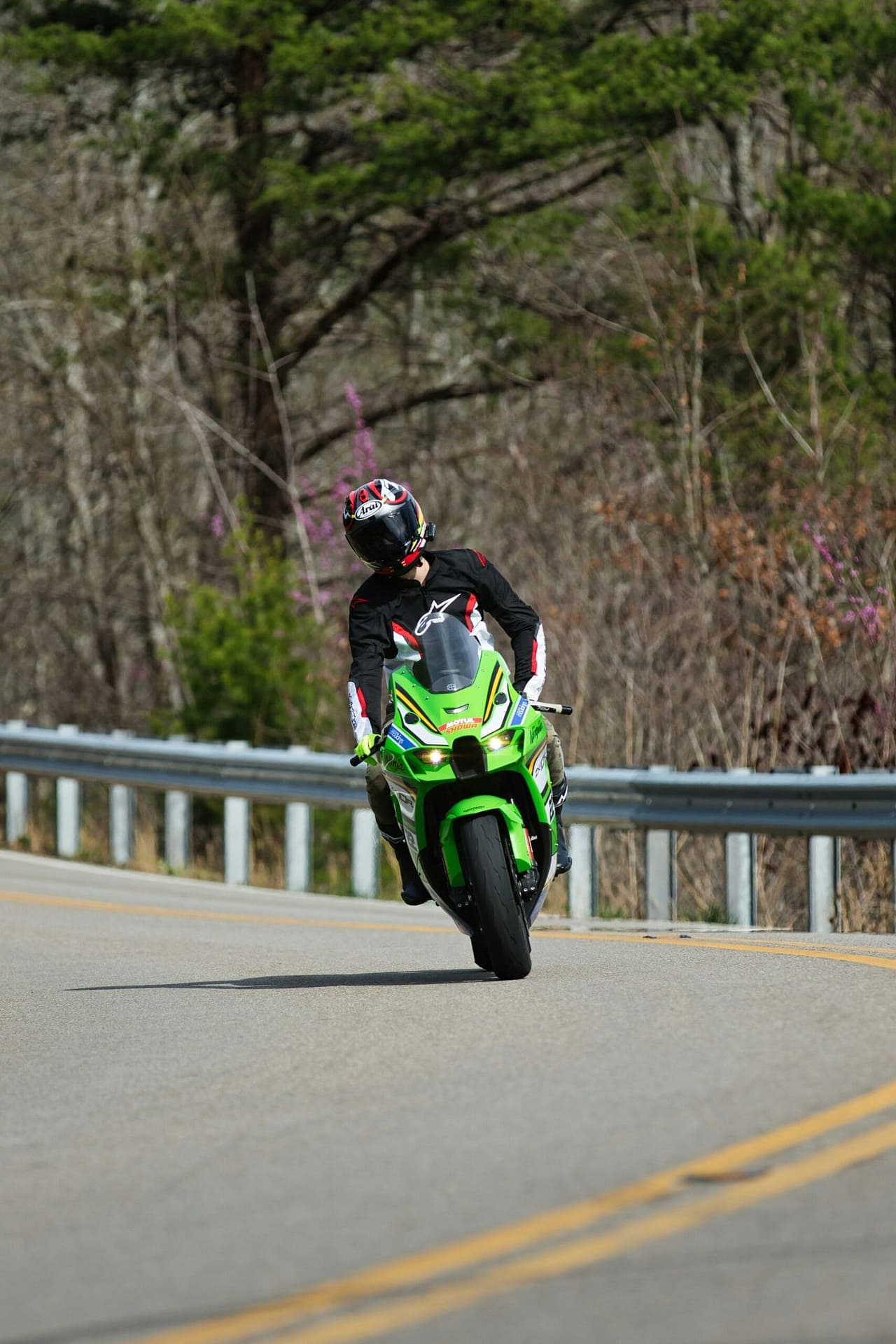 Green Sport Bike Riding on Winding Road