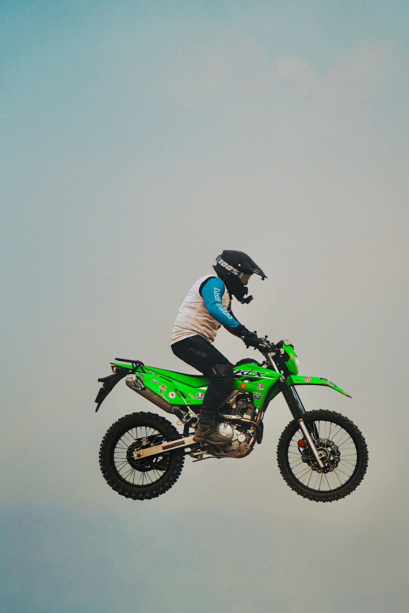 Green Dirt Bike Jumping Over Forest Trail Jump