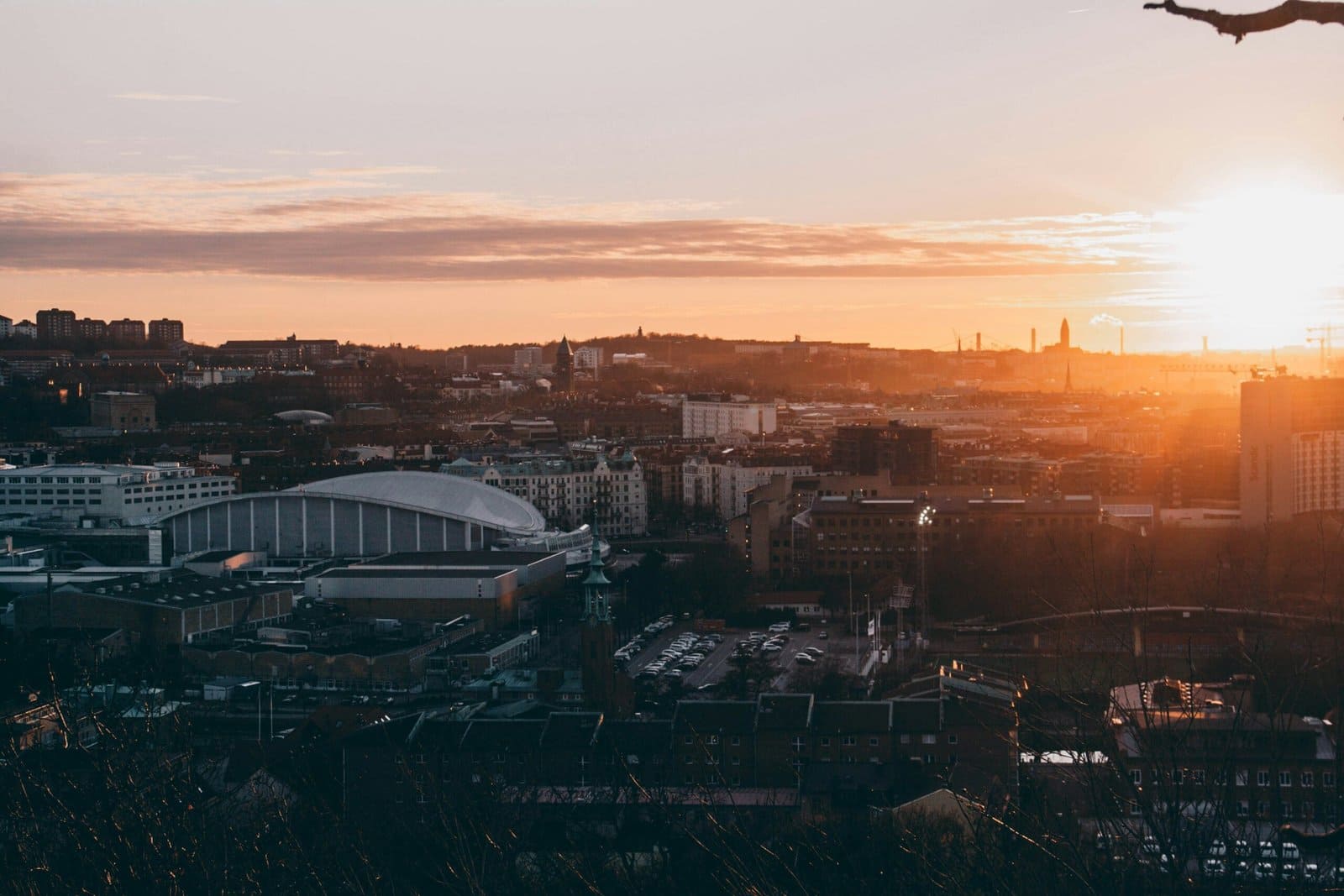 Drone Flying Over a City at Sunset