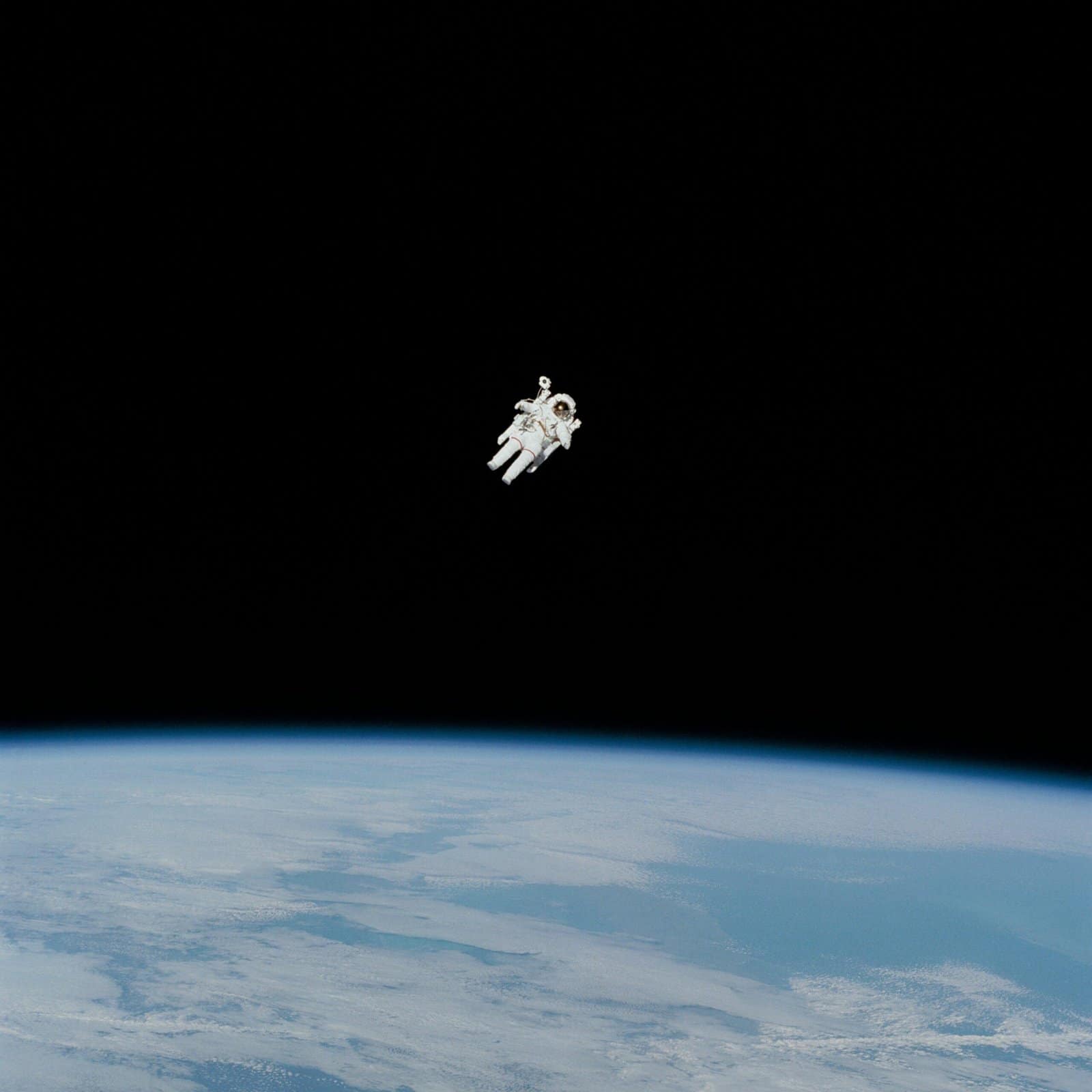Astronaut Floating Above Earth with Glowing City Lights