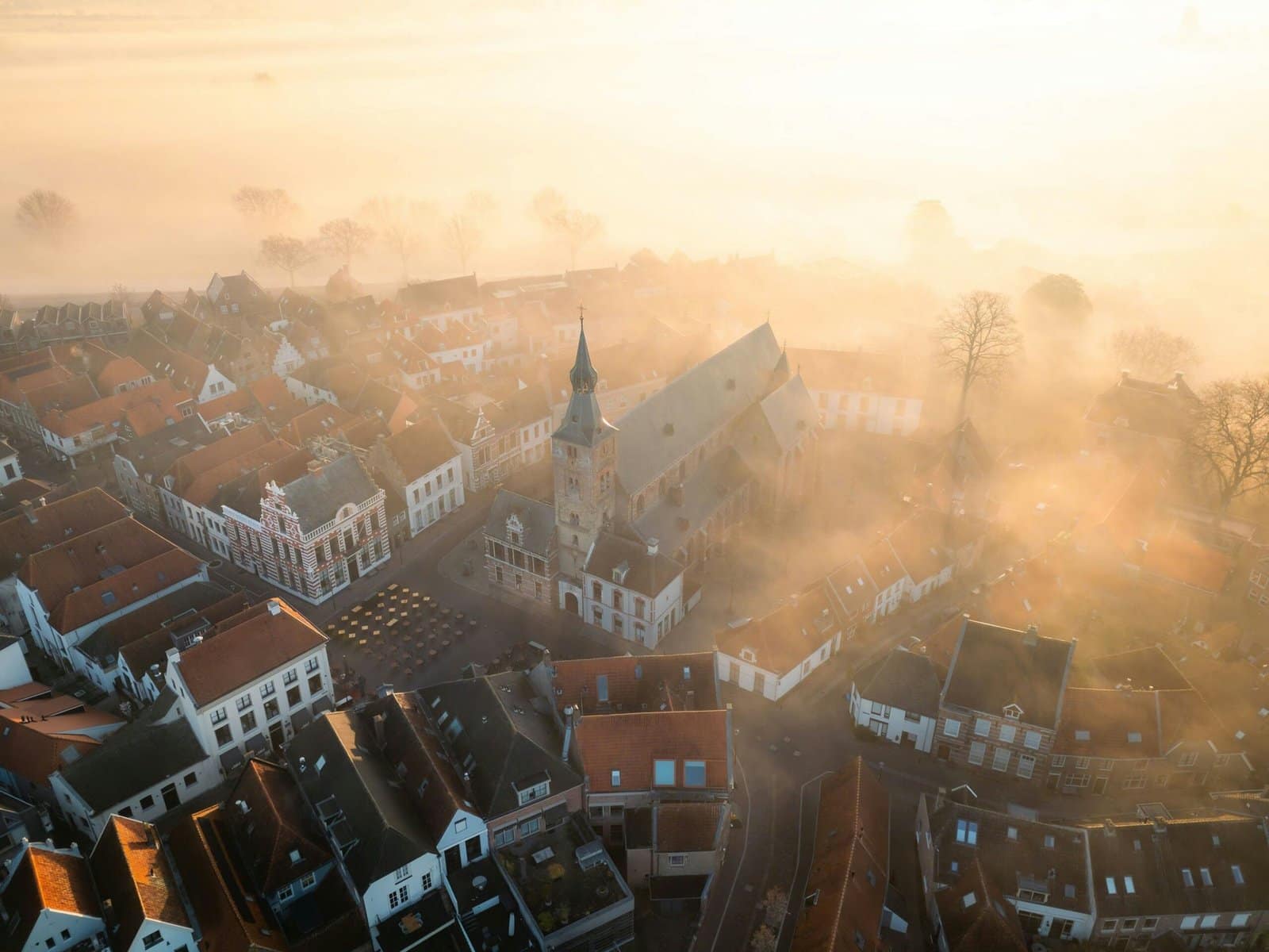 Old Town Rooftops at Sunrise above Golden Mist