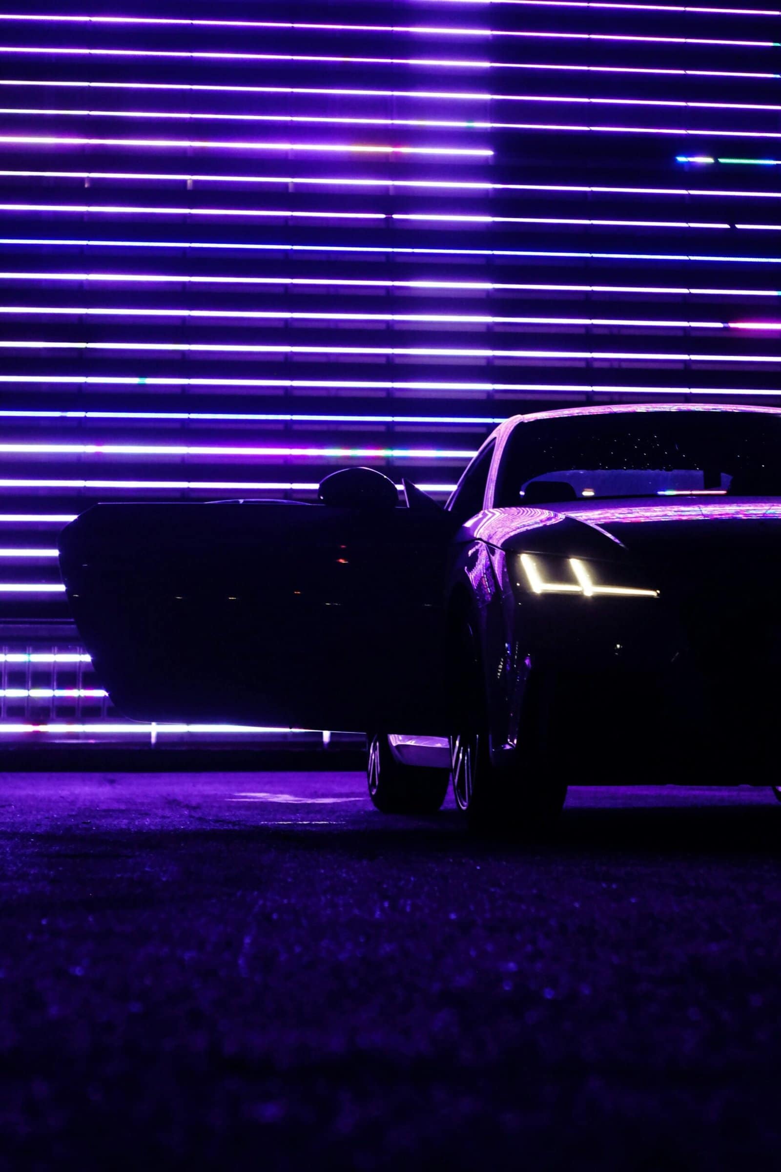 Vintage Muscle Car Under Neon Lights at Night