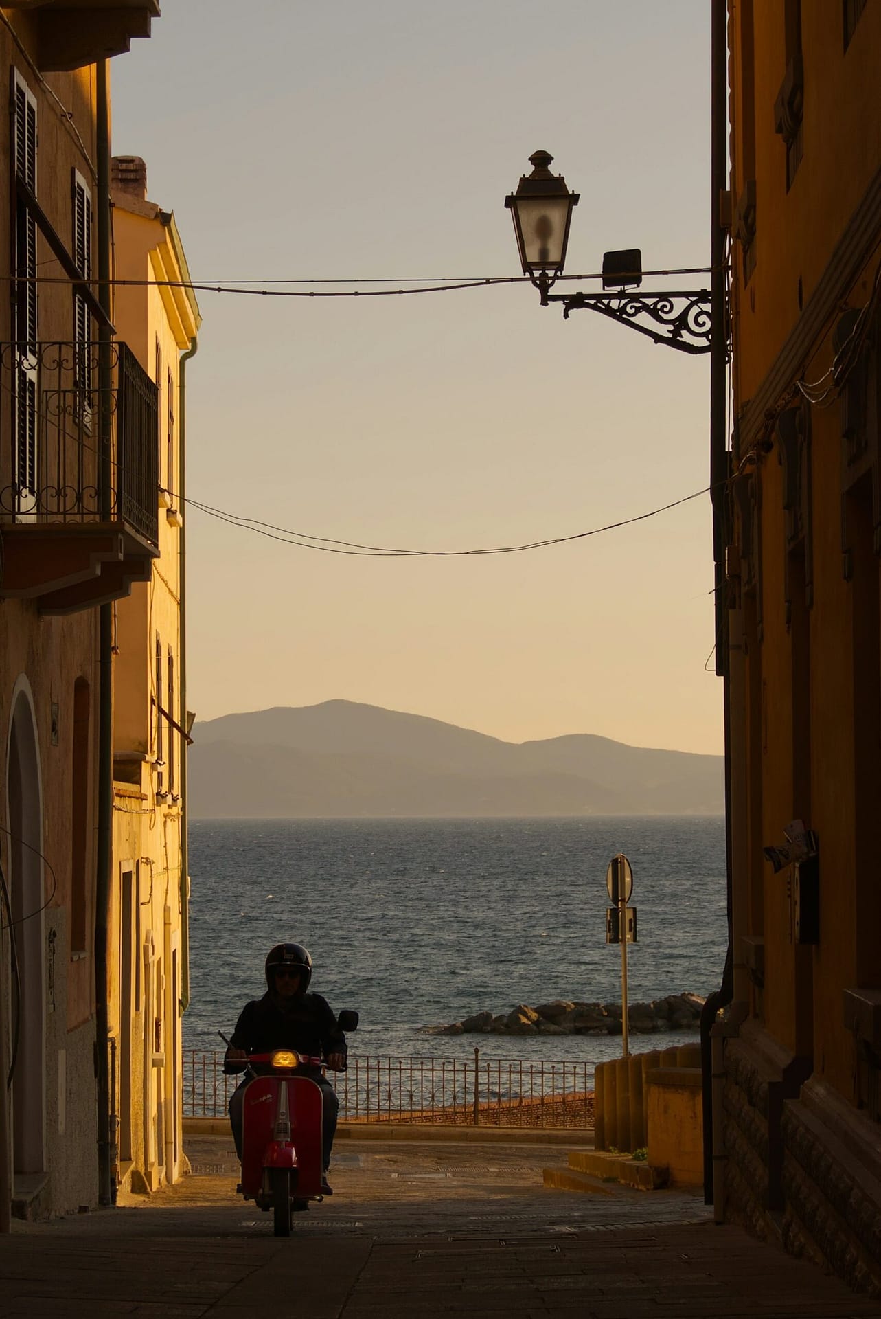 Classic Scooter Riding Towards the Sea
